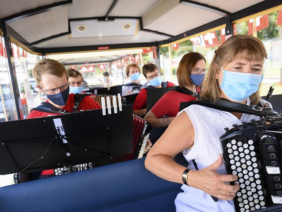 A La Chaux-de-Fonds (NE) l'hymne national a été joué à bord d'un petit train touristique et des habitations ont été ornées de plus de 2300 drapeaux © KEYSTONE/LAURENT GILLIERON