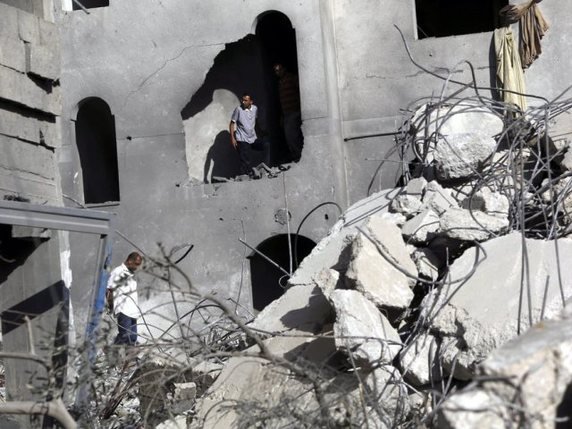 Palestiniens inspectant les ruines d'une maison au nord de Gaza