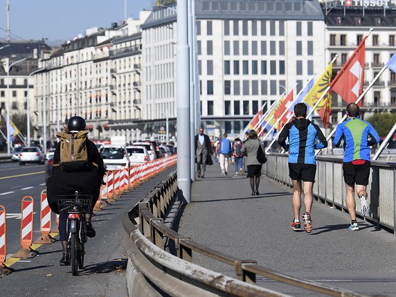 L'OMS appelle les gouvernements à maintenir des infrastructures adaptées pour inciter la population à marcher ou à faire du vélo (ici le pont du Mont-Blanc à Genève, archives). © KEYSTONE/MARTIAL TREZZINI
