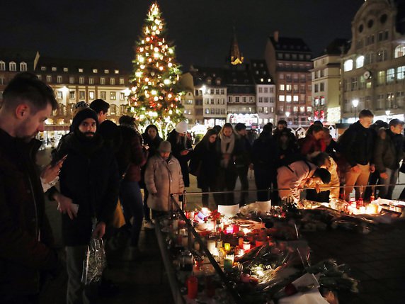 Des passants rendent hommage aux victimes de l'attaque. © KEYSTONE/AP/CHRISTOPHE ENA